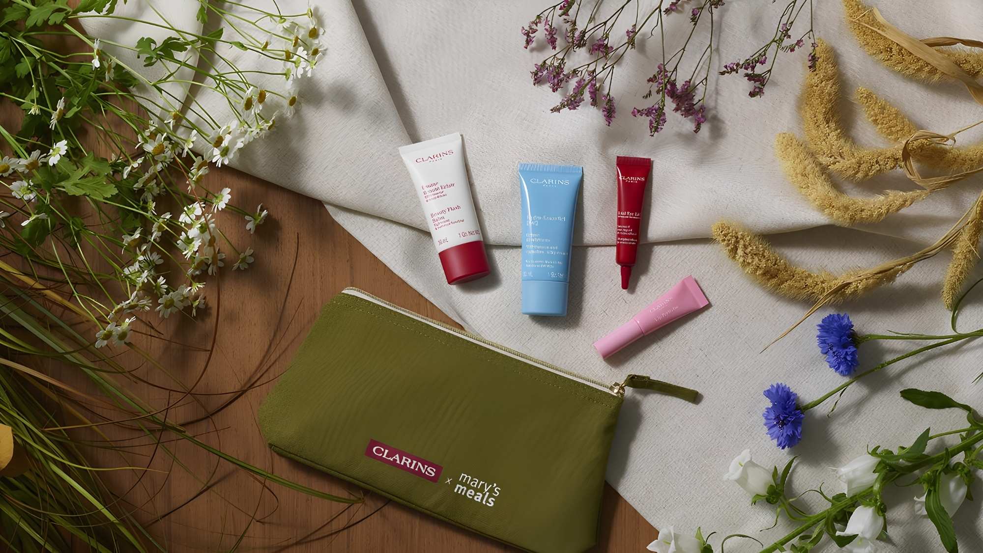 Green organic travel bag from Clarins & Mary's Meals gift with 4 essential skincare products free gift with purchase at Goulds in Dorchester